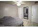 This bedroom has wood laminate flooring, a ceiling fan, and gray walls at 3418 W Roma Ave, Phoenix, AZ 85017