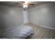 Bedroom with wood floors, neutral paint, a ceiling fan, and a large closet at 3418 W Roma Ave, Phoenix, AZ 85017