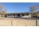 Single story white house with gray trim, a carport, and a block wall at 3418 W Roma Ave, Phoenix, AZ 85017