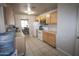 Eat-in kitchen with wood cabinets, white appliances, and tile floors at 3418 W Roma Ave, Phoenix, AZ 85017