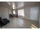 Living room with light wood floors, ceiling fan, sofa and dining table at 3418 W Roma Ave, Phoenix, AZ 85017