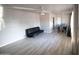 Light and airy living room with light wood flooring, a ceiling fan, and a dark sofa at 3418 W Roma Ave, Phoenix, AZ 85017