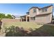 Spacious backyard featuring lush green grass, a covered patio, and a privacy fence at 3556 E Austin Dr, Gilbert, AZ 85296