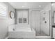 Bright bathroom features subway tile, soaking tub, glass shower, and plantation shutters at 3556 E Austin Dr, Gilbert, AZ 85296