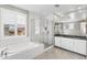 Bright bathroom boasts subway tile surround, soaking tub and tiled shower, and double vanity at 3556 E Austin Dr, Gilbert, AZ 85296