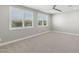 Bright bedroom with plush carpet and two windows offering an abundance of natural light at 3556 E Austin Dr, Gilbert, AZ 85296