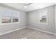 Cozy bedroom with plush carpet, ceiling fan, and windows with stylish shutters at 3556 E Austin Dr, Gilbert, AZ 85296