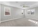 Spacious bedroom with neutral walls, large windows with shutters, and ceiling fan at 3556 E Austin Dr, Gilbert, AZ 85296
