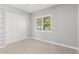 Bright bedroom features neutral paint, a window with plantation shutters, and large closet at 3556 E Austin Dr, Gilbert, AZ 85296