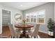 Bright dining room with a round table, four chairs, and a window with plantation shutters at 3556 E Austin Dr, Gilbert, AZ 85296
