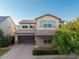 Beautiful two-story home showcasing a brick driveway, two-car garage, neutral stucco, and a tile roof at 3556 E Austin Dr, Gilbert, AZ 85296