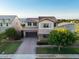 Stunning two-story home features a brick driveway, neutral stucco, manicured landscaping, and a tile roof at 3556 E Austin Dr, Gilbert, AZ 85296