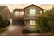 Charming two-story home with a well-manicured front yard and a brick-paved driveway at 3556 E Austin Dr, Gilbert, AZ 85296