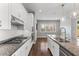 This kitchen has granite countertops, stainless steel appliances, and dark wood flooring at 3556 E Austin Dr, Gilbert, AZ 85296