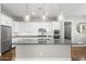 Bright kitchen features white cabinets, granite counters, stainless steel appliances, and pendant lighting over the island at 3556 E Austin Dr, Gilbert, AZ 85296