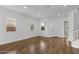 Bright living space features hardwood floors, white trim, and ample natural light from large windows at 3556 E Austin Dr, Gilbert, AZ 85296