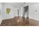 Spacious living room featuring hardwood floors, white trim, staircase access, and abundant natural light at 3556 E Austin Dr, Gilbert, AZ 85296