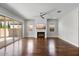 A spacious living room boasts hardwood flooring, a ceiling fan, and a fireplace at 3556 E Austin Dr, Gilbert, AZ 85296