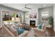 Bright living room with a decorative fireplace, ceiling fan and sliding glass doors leading to the backyard at 3556 E Austin Dr, Gilbert, AZ 85296