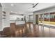 Open-concept living space with hardwood floors, an island kitchen, and access to the patio through sliding glass doors at 3556 E Austin Dr, Gilbert, AZ 85296