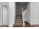 Staircase features carpeted stairs, white railing and paneling, and hardwood floors at 3556 E Austin Dr, Gilbert, AZ 85296