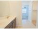 Bathroom featuring double sinks, tile flooring, and a view into the carpeted bedroom at 3611 E Archer Dr, San Tan Valley, AZ 85140