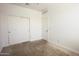 Bedroom featuring neutral carpet, closet and ensuite door at 3611 E Archer Dr, San Tan Valley, AZ 85140