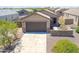 Charming single-story home featuring a two-car garage, desert landscaping, and stone accents on the facade at 3611 E Archer Dr, San Tan Valley, AZ 85140