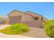 Charming single-story home featuring a two-car garage, desert landscaping, and stone accents on the facade at 3611 E Archer Dr, San Tan Valley, AZ 85140