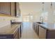 Bright kitchen with stainless steel appliances, a granite-topped island and tile flooring at 3611 E Archer Dr, San Tan Valley, AZ 85140