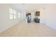 Spacious living room featuring tile floors, ample natural light, and an open layout to the kitchen at 3611 E Archer Dr, San Tan Valley, AZ 85140