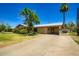 A single-story home with a well-manicured lawn and driveway at 3936 E Oak St, Phoenix, AZ 85006