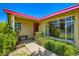 Inviting front entrance with pink trim, large windows, and lush greenery along the walkway at 3936 E Oak St, Phoenix, AZ 85006