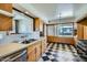 Bright kitchen with checkerboard flooring, stainless steel appliances, and vintage-inspired cabinetry at 3936 E Oak St, Phoenix, AZ 85006