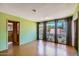 Green-walled Living room with multiple windows, natural light, and a connected doorway at 3936 E Oak St, Phoenix, AZ 85006