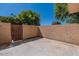 Empty back patio enclosed by a brick wall, featuring a metal gate on the left at 4268 N 68Th Ave, Phoenix, AZ 85033