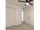 Bedroom with carpet floors, fan and double door closets for easy storage at 4268 N 68Th Ave, Phoenix, AZ 85033