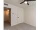 Neutral bedroom with a ceiling fan, and a closet and view into a connected room at 4268 N 68Th Ave, Phoenix, AZ 85033