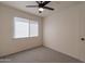 Bright bedroom featuring gray carpet, white walls, and a ceiling fan with lights at 4268 N 68Th Ave, Phoenix, AZ 85033