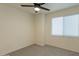 Cozy bedroom with a ceiling fan, plush carpet, and a bright window at 4268 N 68Th Ave, Phoenix, AZ 85033