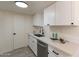 Modern kitchen with white cabinets, quartz countertops, stainless steel appliances, and stylish finishes at 4268 N 68Th Ave, Phoenix, AZ 85033