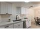 Bright kitchen features white cabinetry, sleek countertops, and stainless steel appliances at 4268 N 68Th Ave, Phoenix, AZ 85033