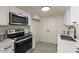 Modern kitchen with white cabinets, quartz countertops, stainless steel appliances, and stylish finishes at 4268 N 68Th Ave, Phoenix, AZ 85033
