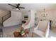 Spacious living room with stairs, modern decor, stylish furnishings, and an adjacent dining area with natural light at 4268 N 68Th Ave, Phoenix, AZ 85033