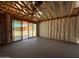 Exposed wood beam ceiling of home under construction, revealing sliding glass doors and insulation at 46868 W Coe St, Maricopa, AZ 85139