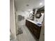 Bathroom with a modern vanity, double sinks, decorative mirrors, and a shower with a patterned curtain at 4729 W Eva St, Glendale, AZ 85302