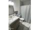 Bathroom featuring a single sink vanity, toilet, shower with curtain, and neutral color scheme at 4729 W Eva St, Glendale, AZ 85302