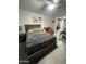 Well-lit primary bedroom featuring neutral wall colors, closet, seating area, and tile floors at 4729 W Eva St, Glendale, AZ 85302