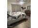 A cozy bedroom with a queen-sized bed, stylish linens, and wood-look flooring at 4729 W Eva St, Glendale, AZ 85302