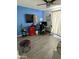 Bright home office space with a desk setup, a mini fridge, blue accent wall, and light-colored flooring at 4729 W Eva St, Glendale, AZ 85302